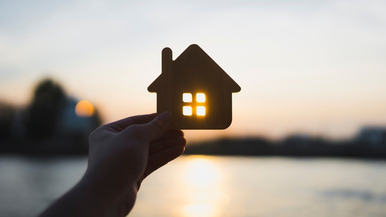 House silhouette in hand — “Find the best mortgage rates for your next property purchase.”