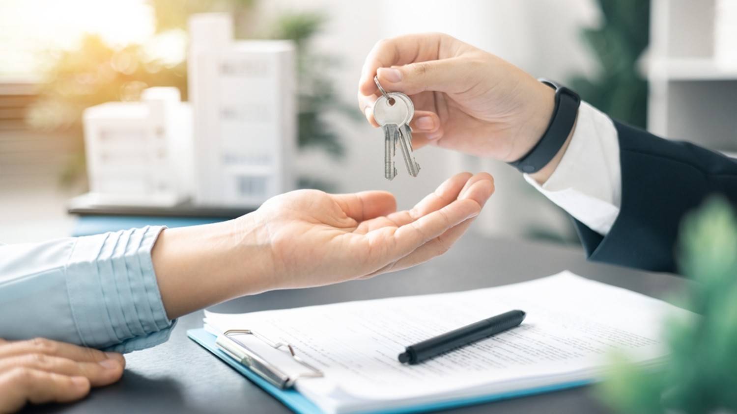 Person handing over house keys — “Secure your home loan with top mortgage advisors in Mission, BC.”